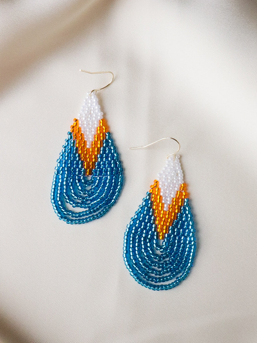 Handmade Sunrise Drop beaded teardrop earrings in white, golden yellow, and ocean blue, lightweight jewelry that brightens the face