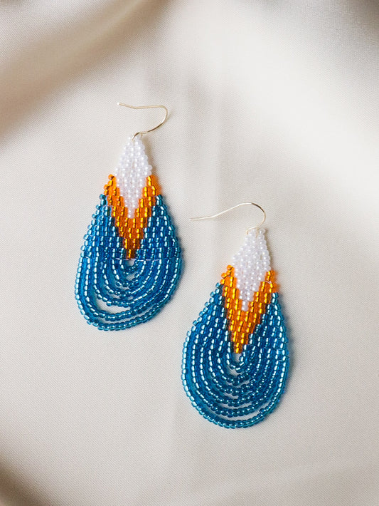 Handmade Sunrise Drop beaded teardrop earrings in white, golden yellow, and ocean blue, lightweight jewelry that brightens the face